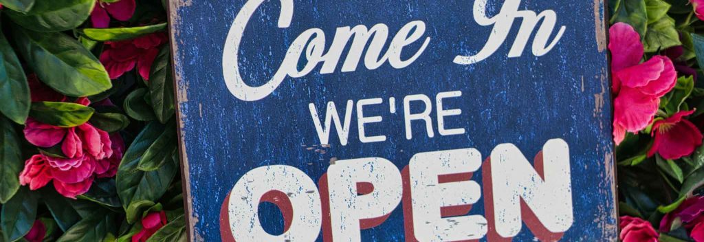 An "Open for Business" sign in a window
